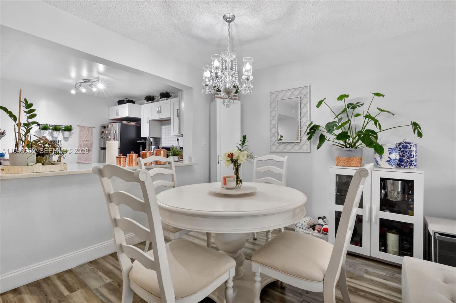8150 West McNab Road, Unit 304 Tamarac, FL 33321 - Photo 11 of 33 a dining room with furniture and chandelier