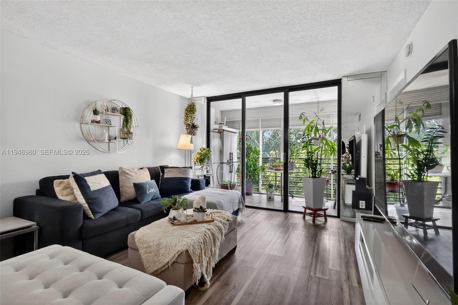 8150 West McNab Road, Unit 304 Tamarac, FL 33321 - Photo 12 of 33 a living room with furniture and a large window