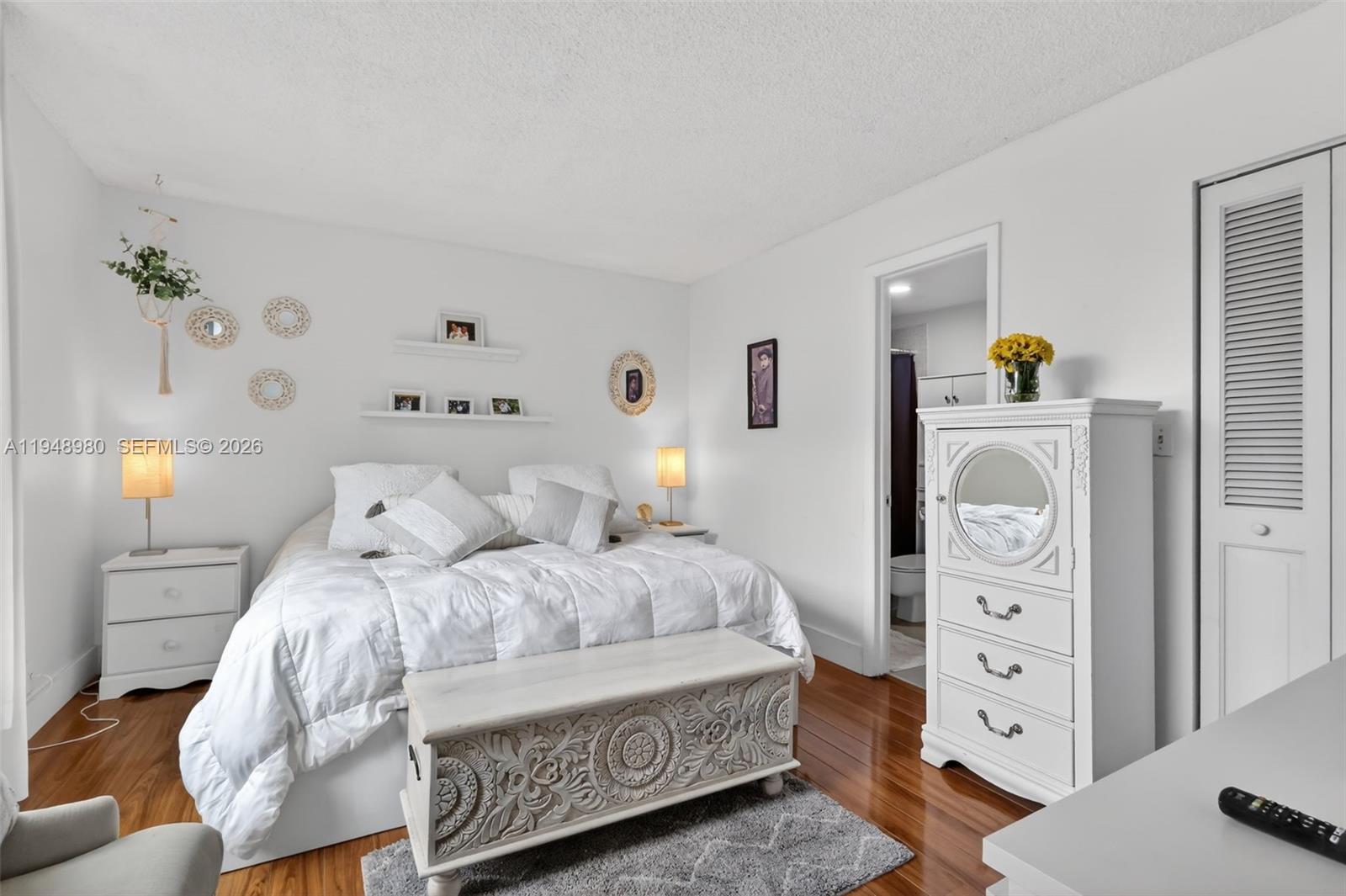 8150 West McNab Road, Unit 304 Tamarac, FL 33321 - Photo 20 of 33 a bedroom with a bed and a dresser