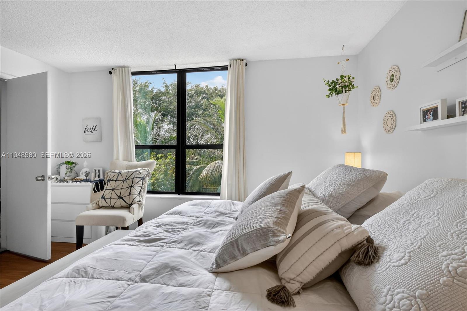 8150 West McNab Road, Unit 304 Tamarac, FL 33321 - Photo 22 of 33 a bedroom with a bed and a large window