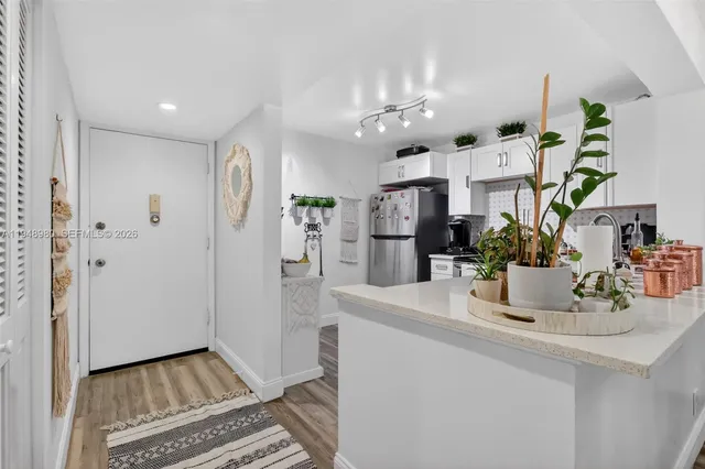 a view of kitchen with refrigerator and counter top