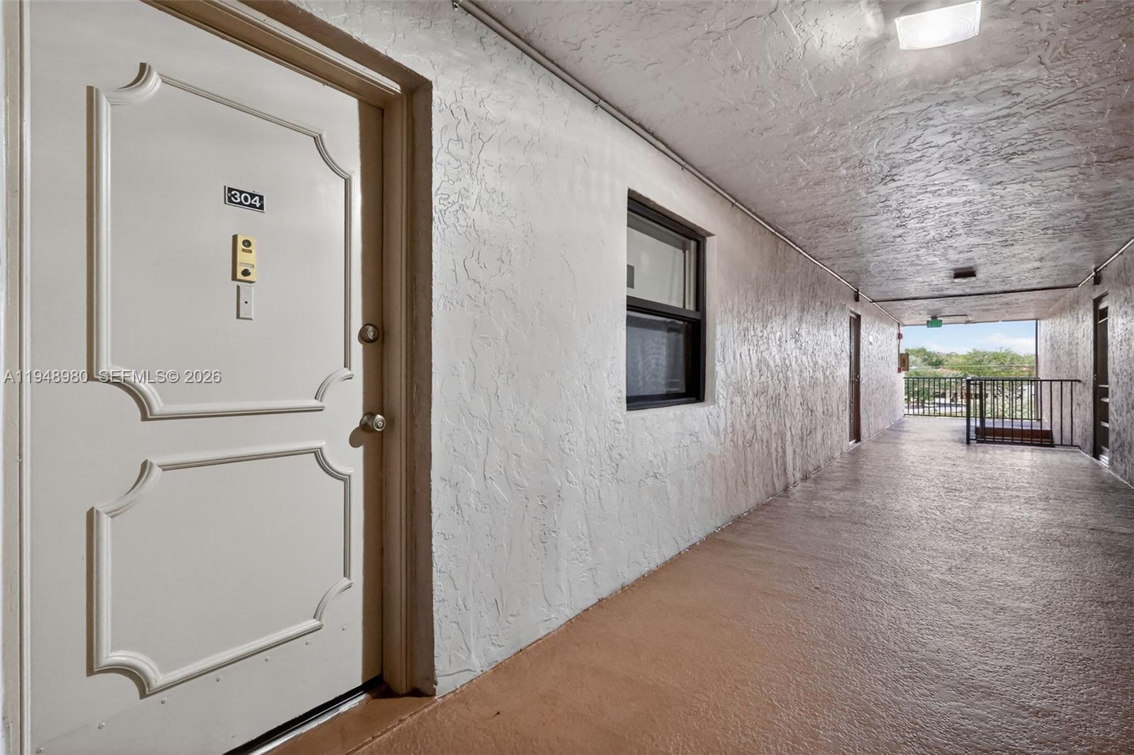 8150 West McNab Road, Unit 304 Tamarac, FL 33321 - Photo 33 of 33 a view of a hallway with interior of the house