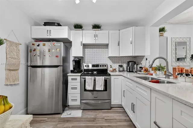 a kitchen with a refrigerator and a sink