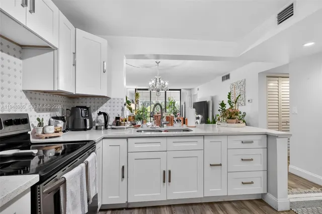 a kitchen with white cabinets and a sink