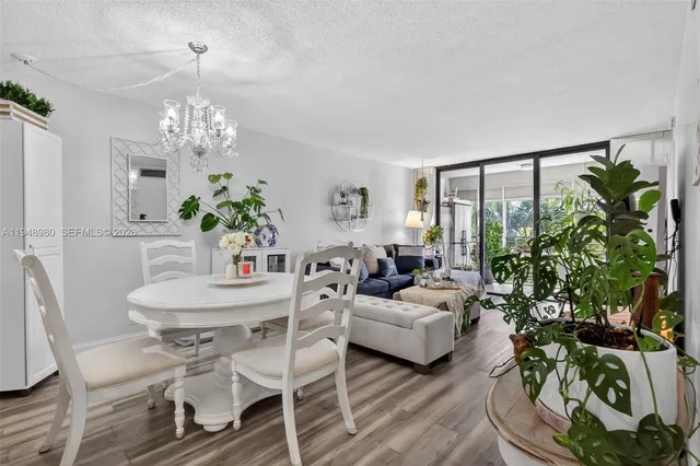 a living room with furniture a chandelier and a fireplace