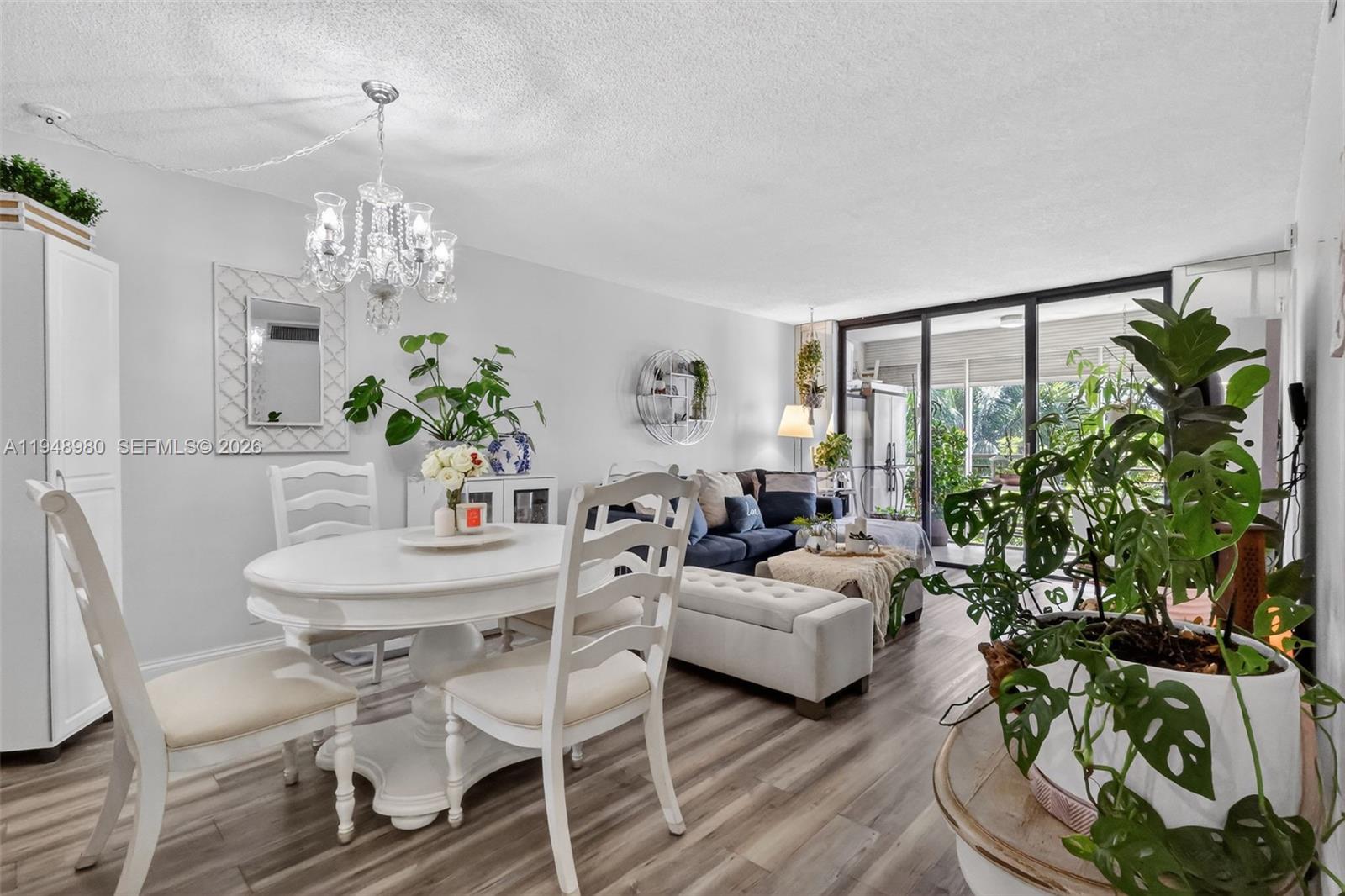 8150 West McNab Road, Unit 304 Tamarac, FL 33321 - Photo 9 of 33 a living room with furniture a chandelier and a fireplace
