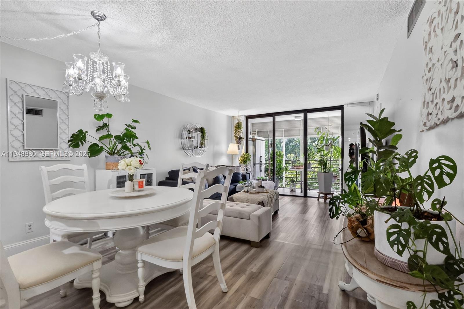 8150 West McNab Road, Unit 304 Tamarac, FL 33321 - Photo 10 of 33 a living room with furniture and a chandelier