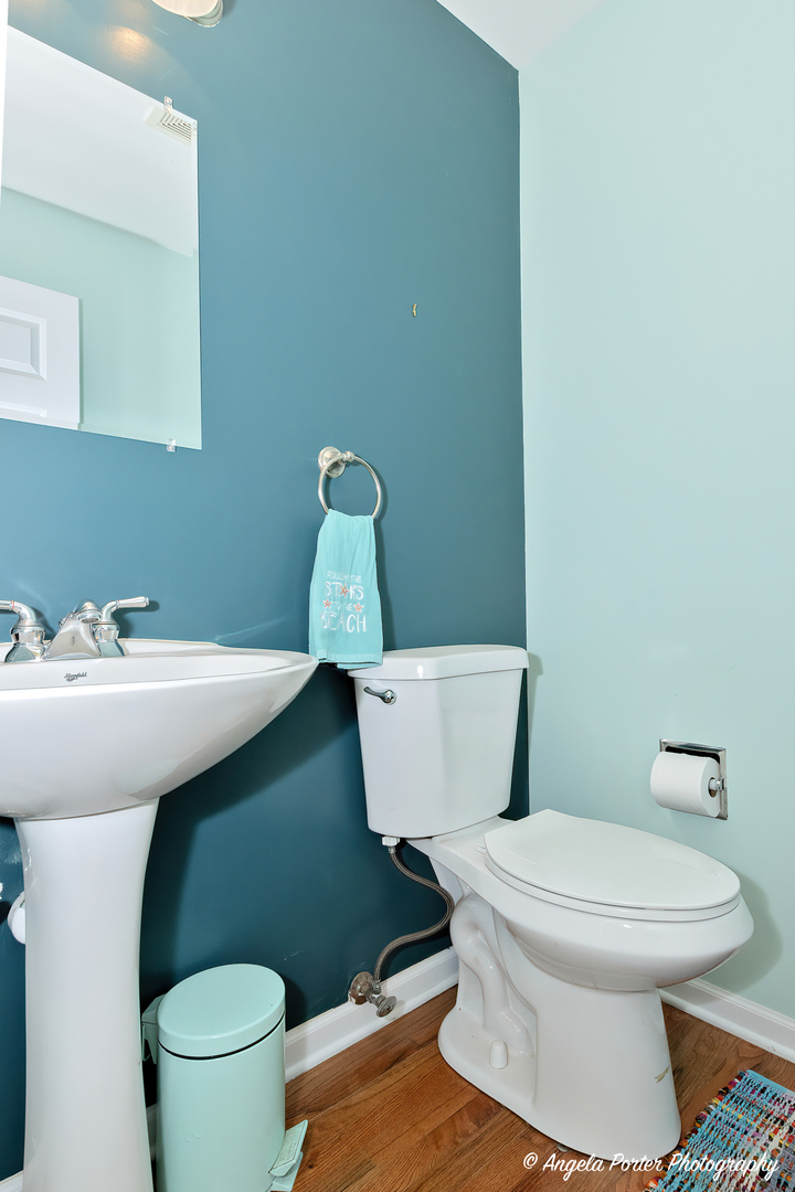 6715 Normandy Drive Spring Grove, IL 60081 - Photo 13 of 31 a white toilet sitting next to a bathroom sink