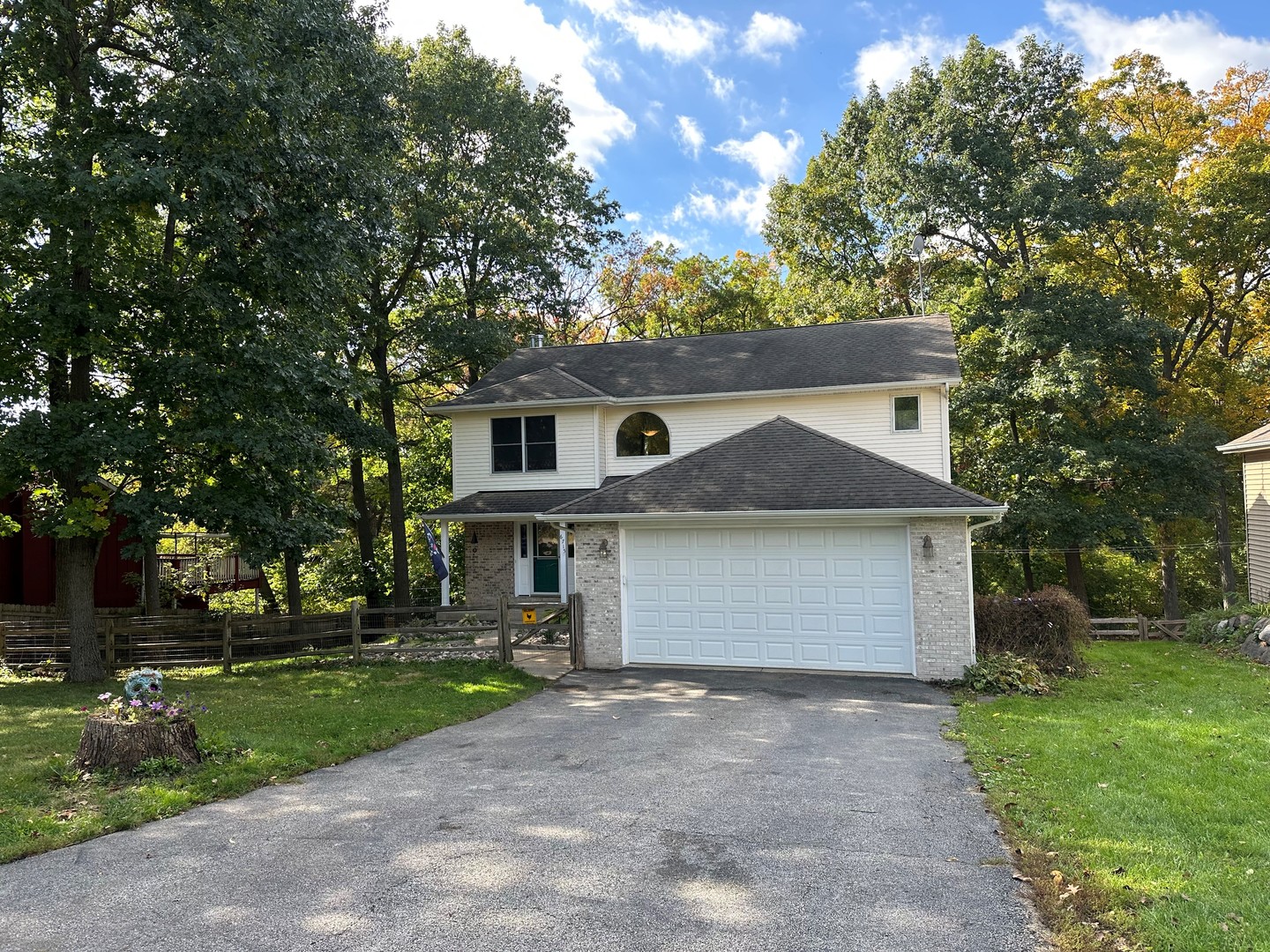 6715 Normandy Drive Spring Grove, IL 60081 - Photo 29 of 31 a front view of a house with a yard and garage