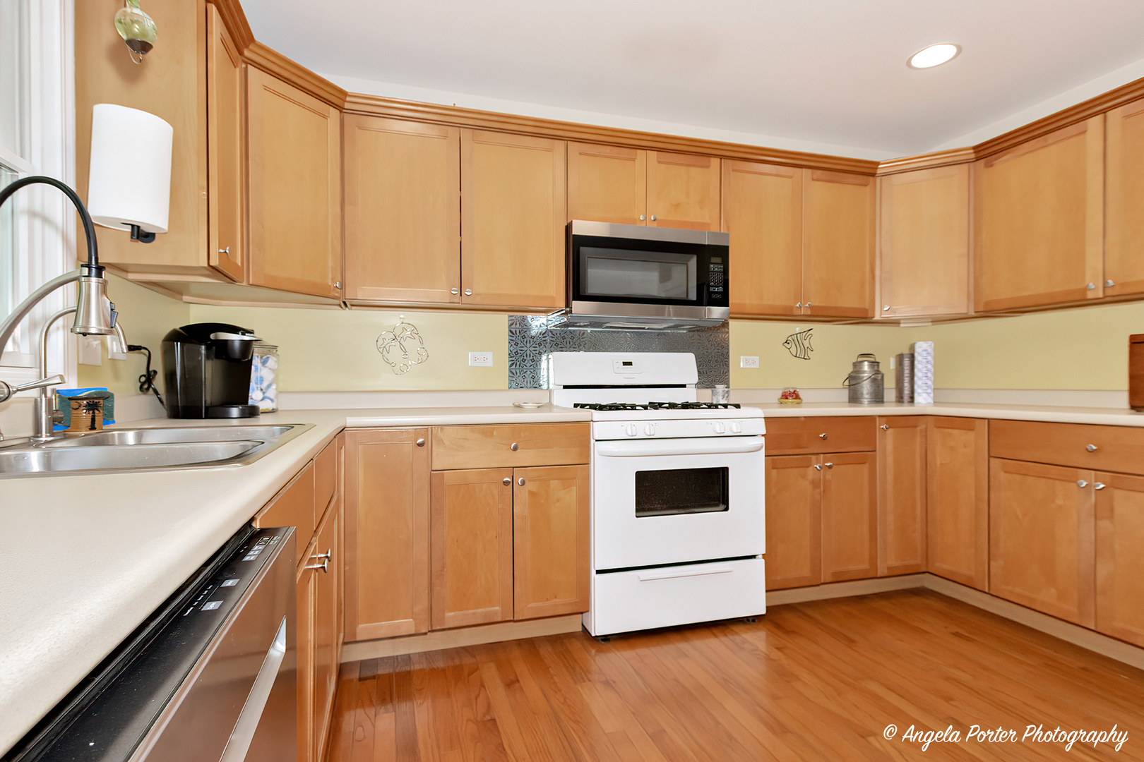 6715 Normandy Drive Spring Grove, IL 60081 - Photo 9 of 31 a kitchen with stainless steel appliances white cabinets a sink and a stove