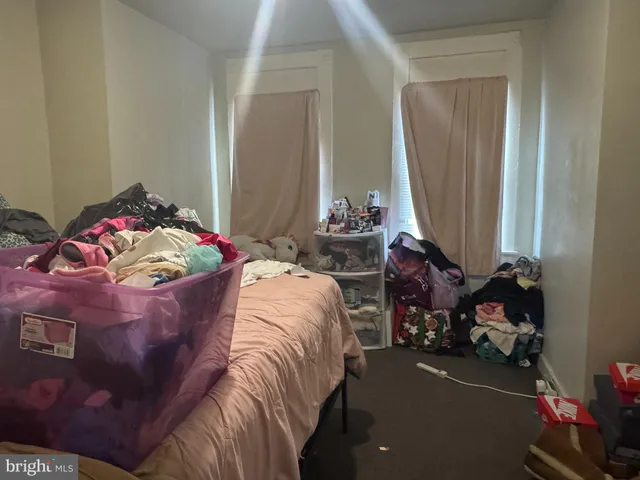 a bed sitting in a bedroom next to a window