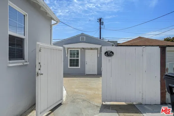 a front view of a house with a wooden fence