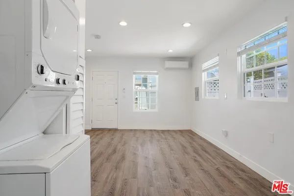a view of a kitchen with wooden floor and windows