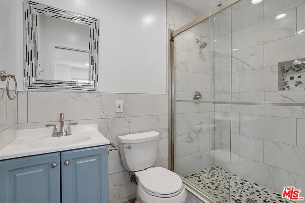 a bathroom with a toilet sink and shower