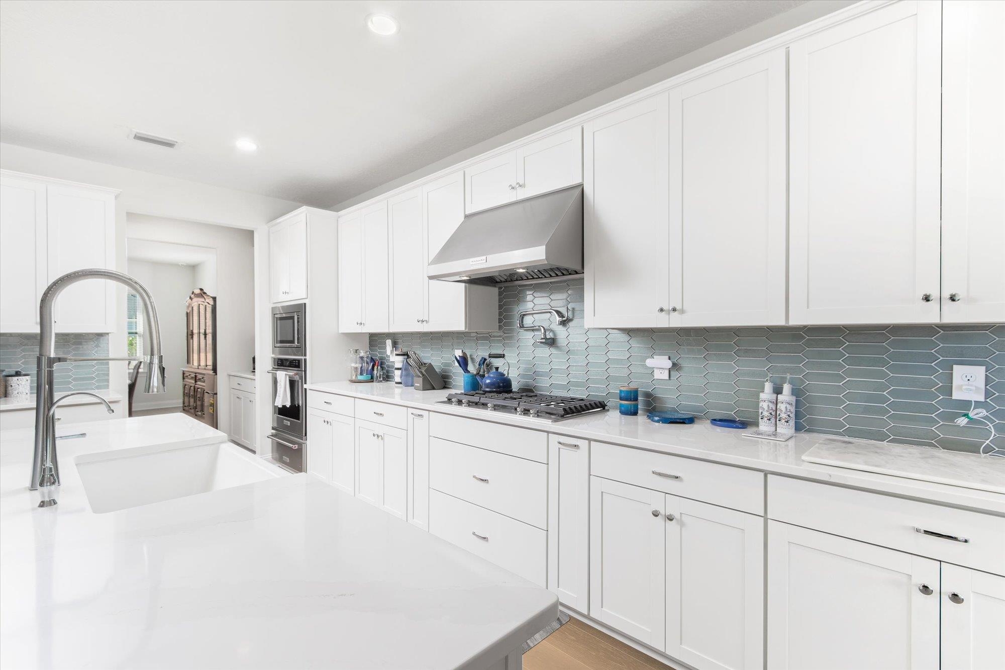 41 Cinnamon Teal Way St. Augustine, FL 32092 - Photo 14 of 60 a kitchen with stainless steel appliances granite countertop a sink a stove and white cabinets