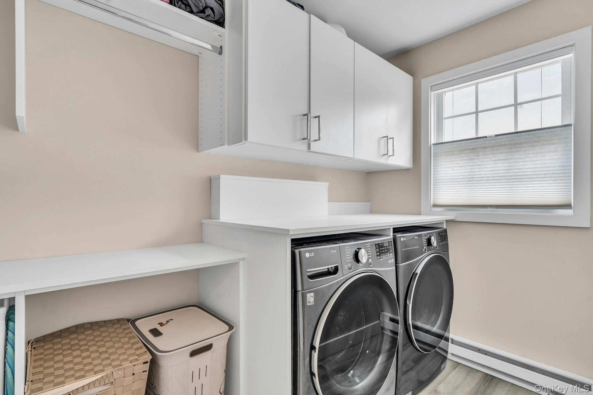 20 Robert Road Glen Cove, NY 11542 - Photo 17 of 23 New Laundry room on second floor with custom cabinetry and a place to hang laundry and fold plus a place to put the hampers.