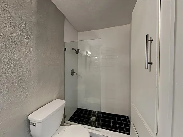 a bathroom with a toilet a sink and shower