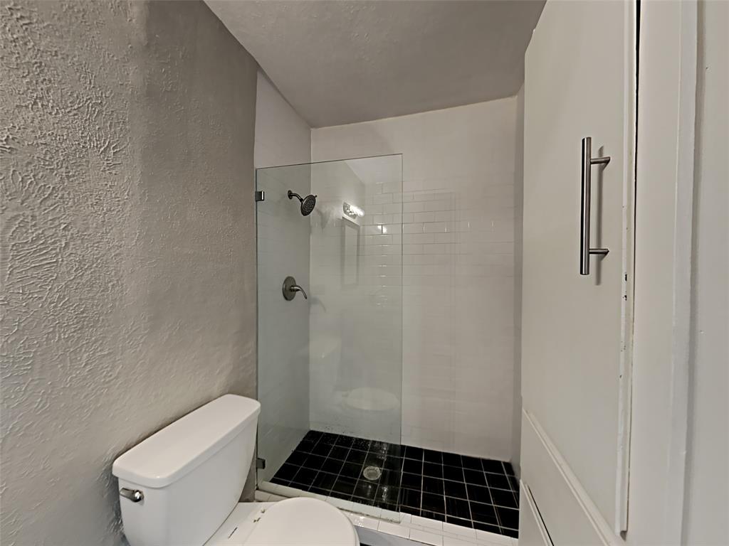 5105 Skillman Street, Unit 120E Dallas, TX 75206 - Photo 13 of 15 a bathroom with a toilet a sink and shower