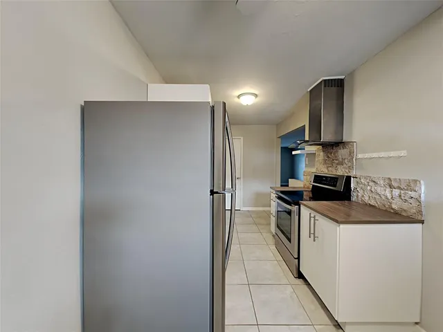 a kitchen with stainless steel appliances granite countertop a sink and a refrigerator