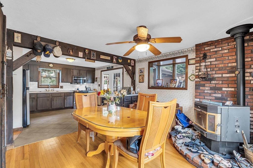 113 Walnut Road Tewksbury, MA 01876 - Photo 11 of 38 a view of a dining room with furniture and a kitchen