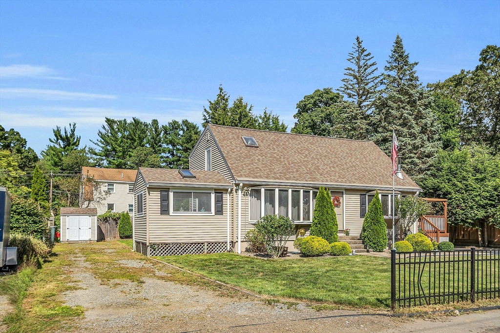 113 Walnut Road Tewksbury, MA 01876 - Photo 3 of 38 a front view of a house with a yard table and chairs