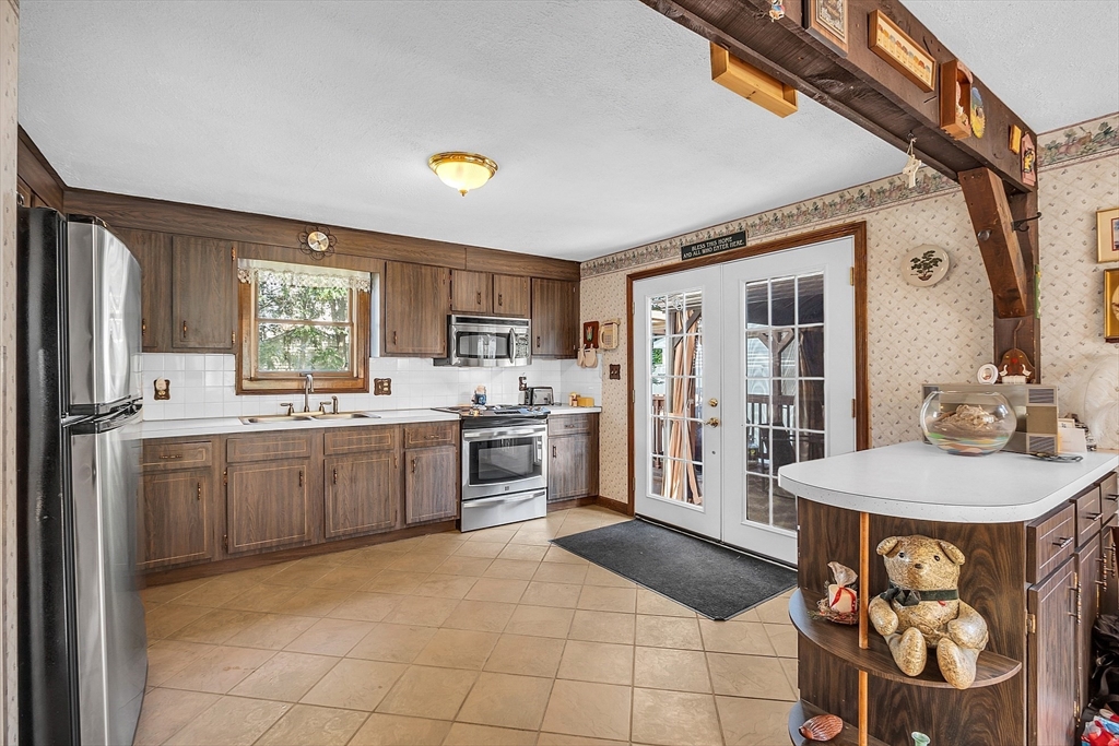 113 Walnut Road Tewksbury, MA 01876 - Photo 8 of 38 a kitchen with a sink appliances and cabinets