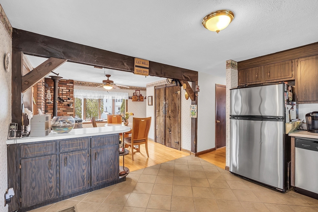 113 Walnut Road Tewksbury, MA 01876 - Photo 10 of 38 a kitchen with a refrigerator and a sink