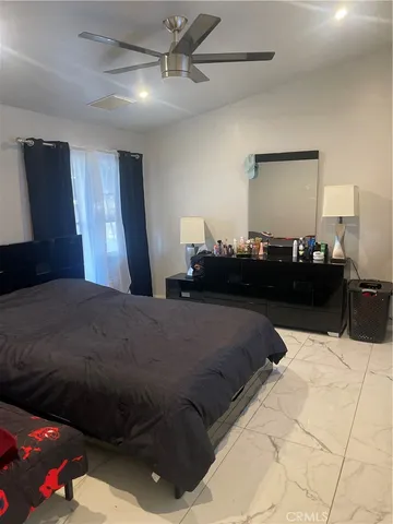 a bedroom with a bed and a lamp