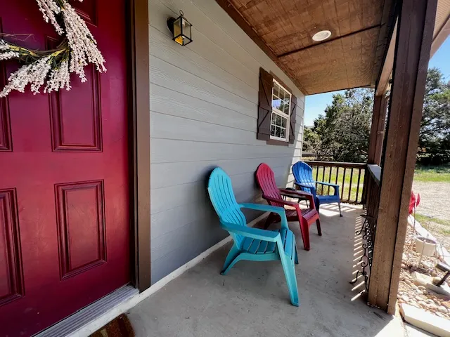 a view of a two chairs in the balcony