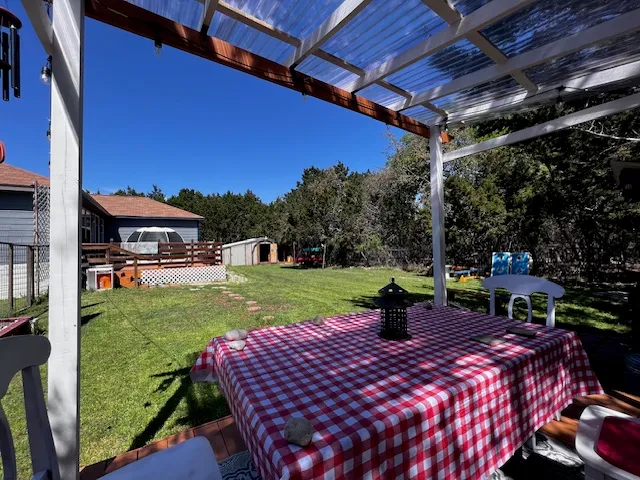 a view of a porch with furniture and garden