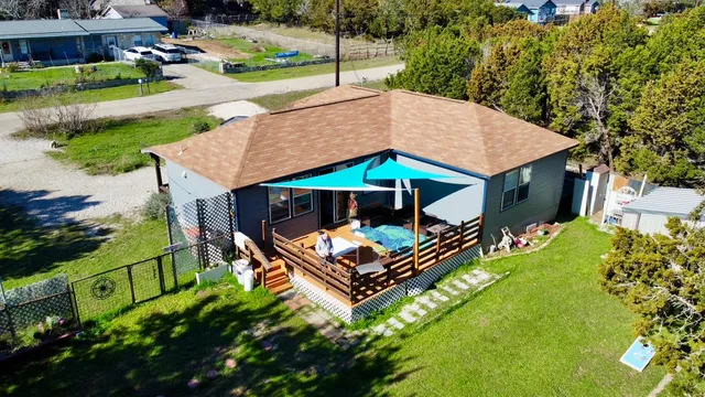 an aerial view of a house with garden space and street view