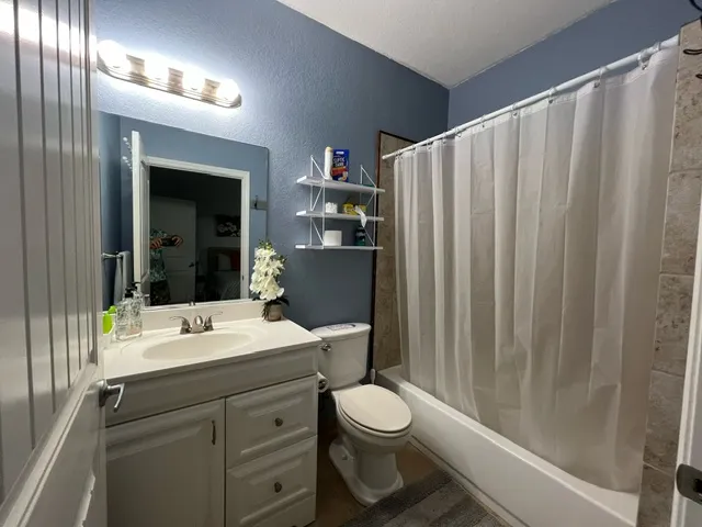 a bathroom with a toilet a sink and a mirror