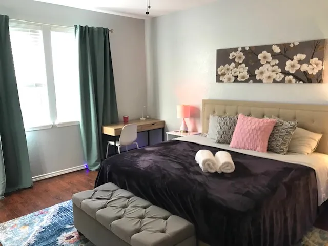 a living room with furniture and wooden floor
