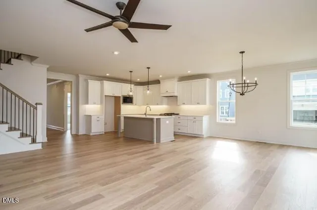 a view of a kitchen with wooden floor and a window