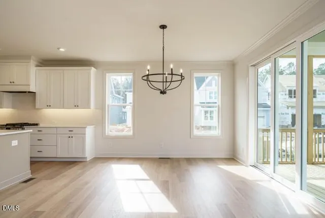 a kitchen with window wooden floor and stainless steel appliances