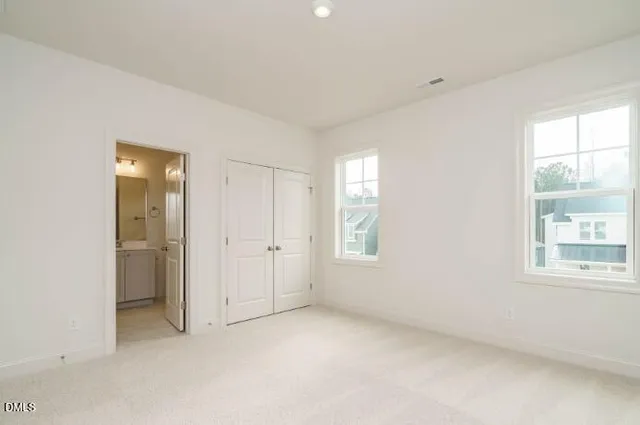 a view of empty room with wooden floor and window