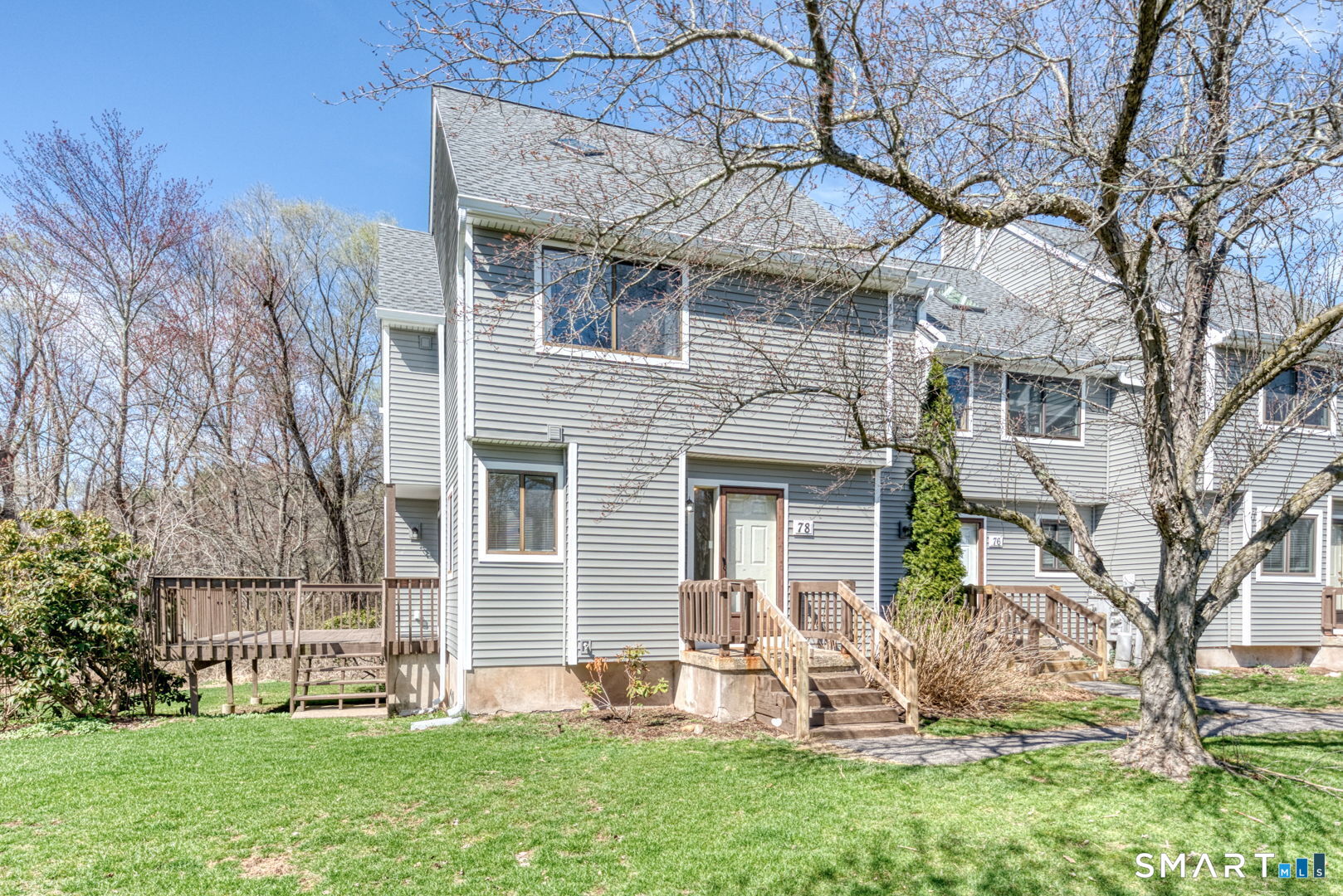 78 Silo Way, Unit 78 Bloomfield, CT 06002 - Photo 1 of 27 a front view of a house with a yard and large tree
