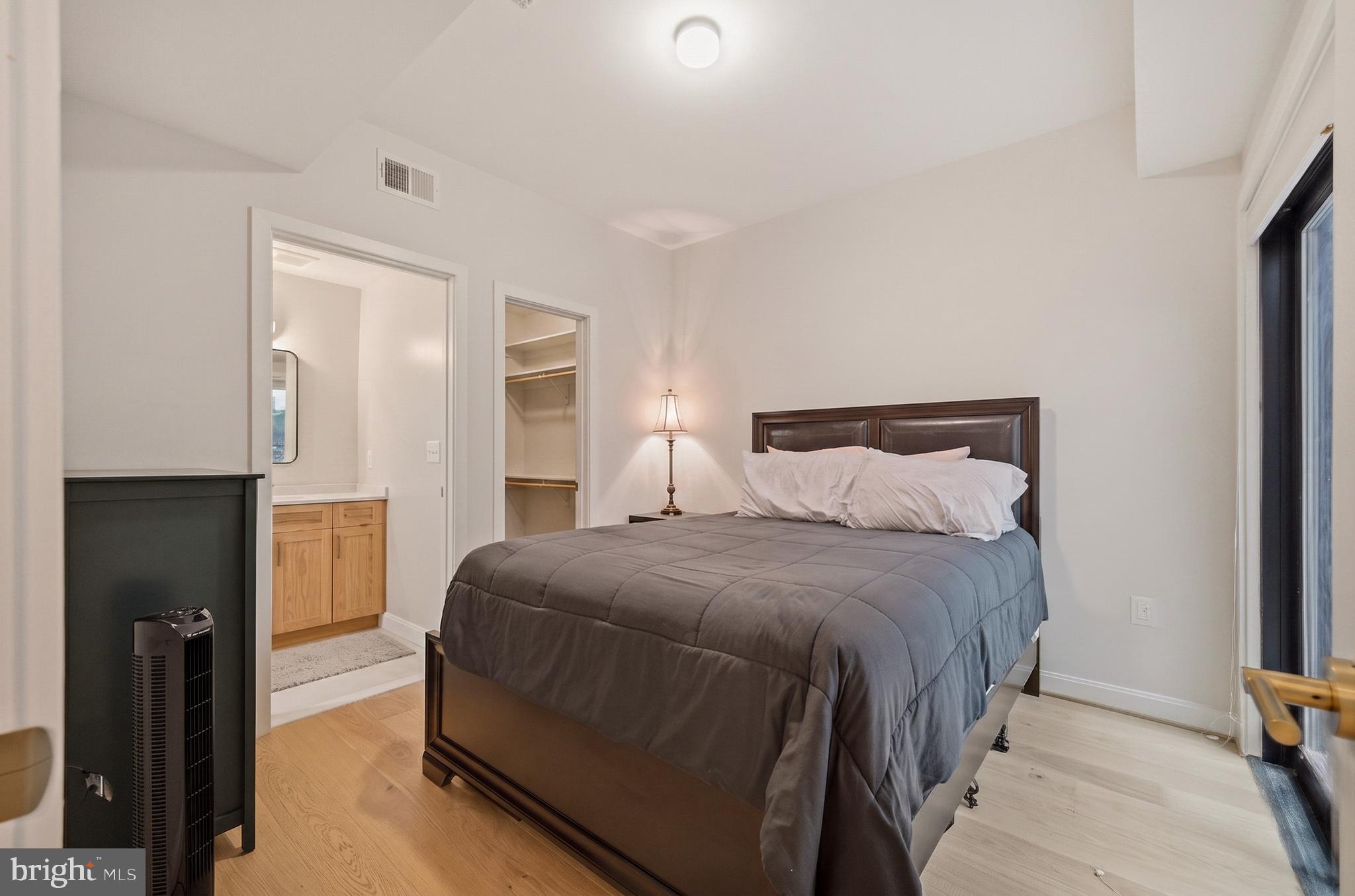 1402 12th Street Northwest, Unit 3 Washington, DC 20005 - Photo 16 of 23 a bedroom with a bed and a walk in closet