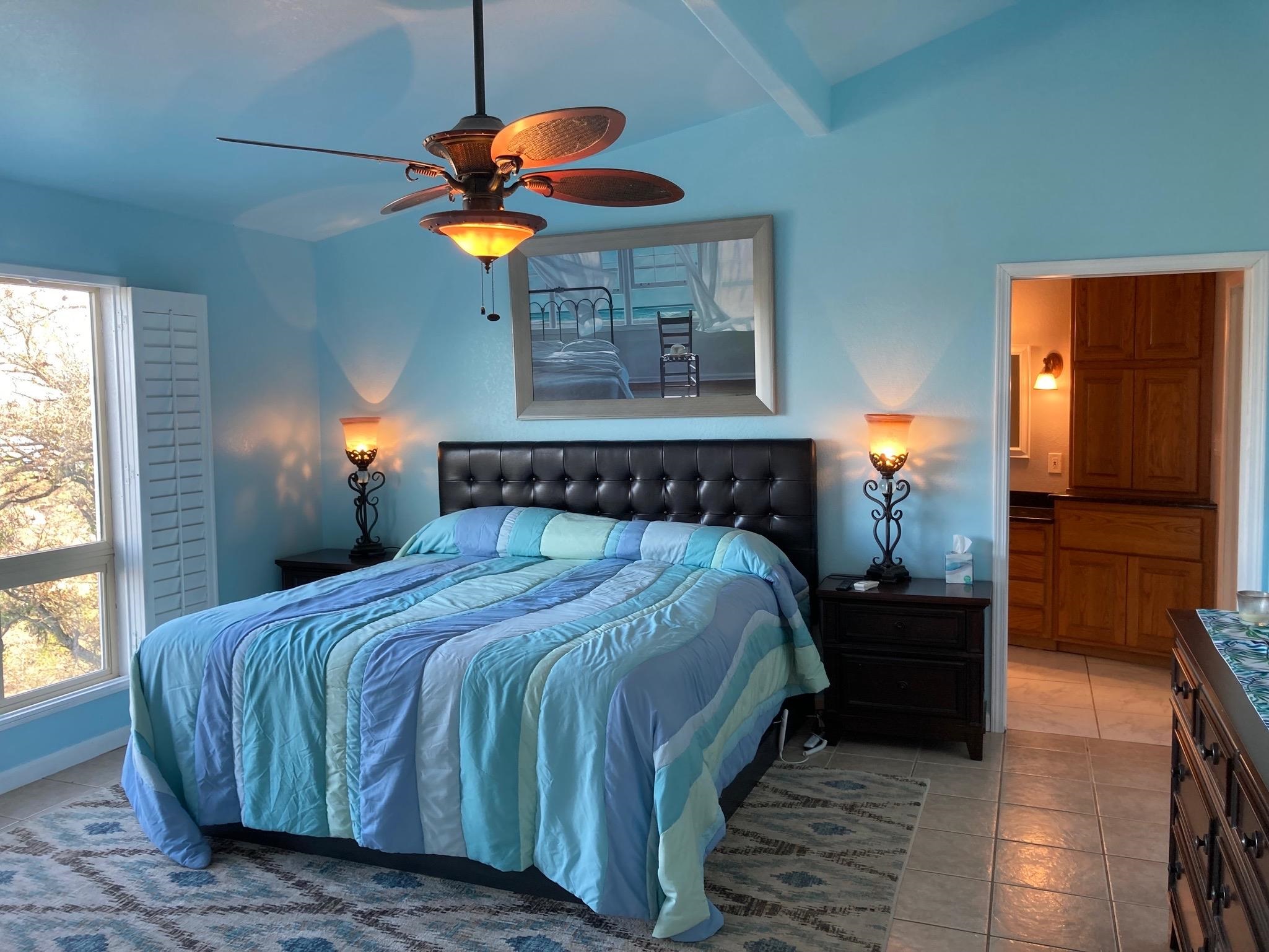 215 Mountain Top Sunrise Beach, TX 78643 - Photo 11 of 29 a bedroom with a bed and a window