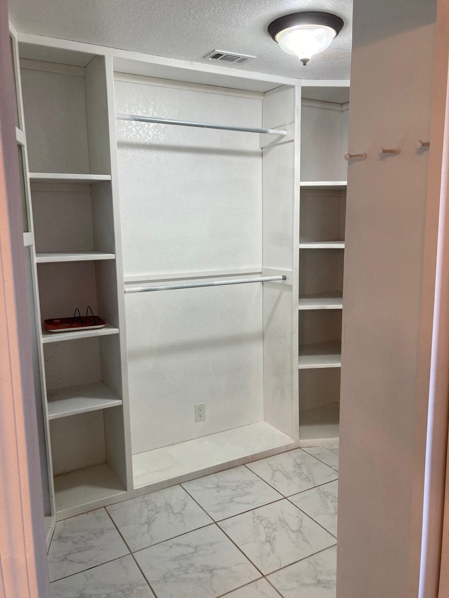 215 Mountain Top Sunrise Beach, TX 78643 - Photo 14 of 29 a view of walk in closet with empty racks