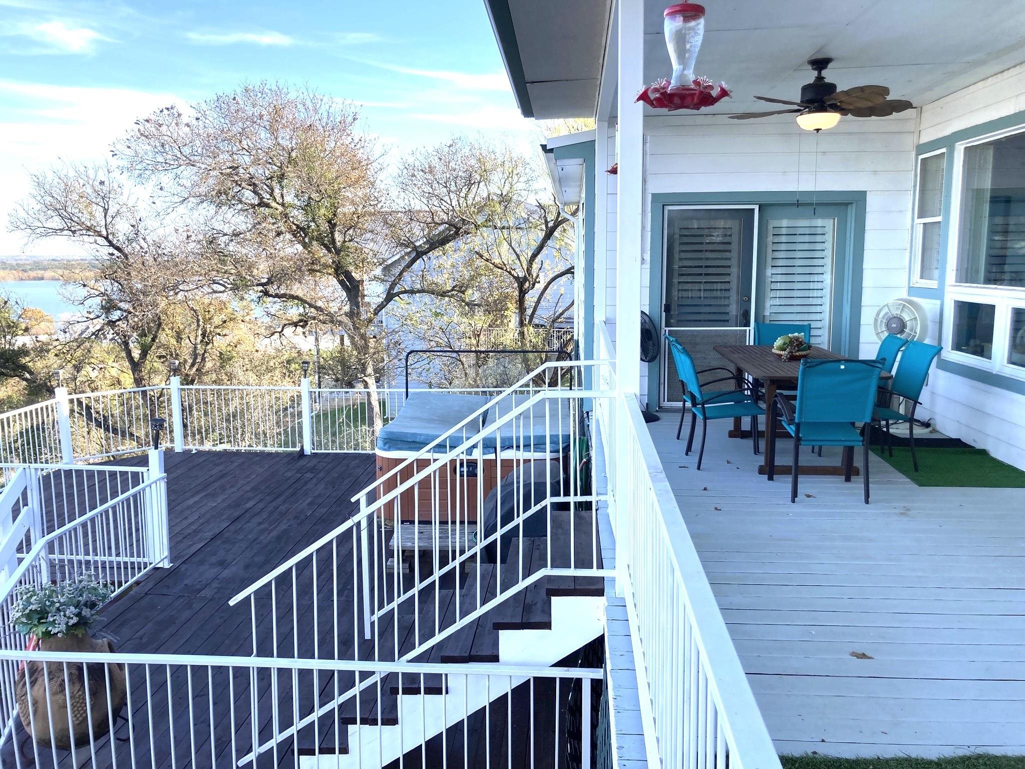 215 Mountain Top Sunrise Beach, TX 78643 - Photo 16 of 29 a view of a roof deck with table and chairs and wooden floor