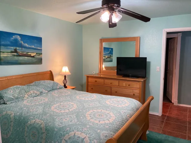 a bedroom with a bed and a dresser in it