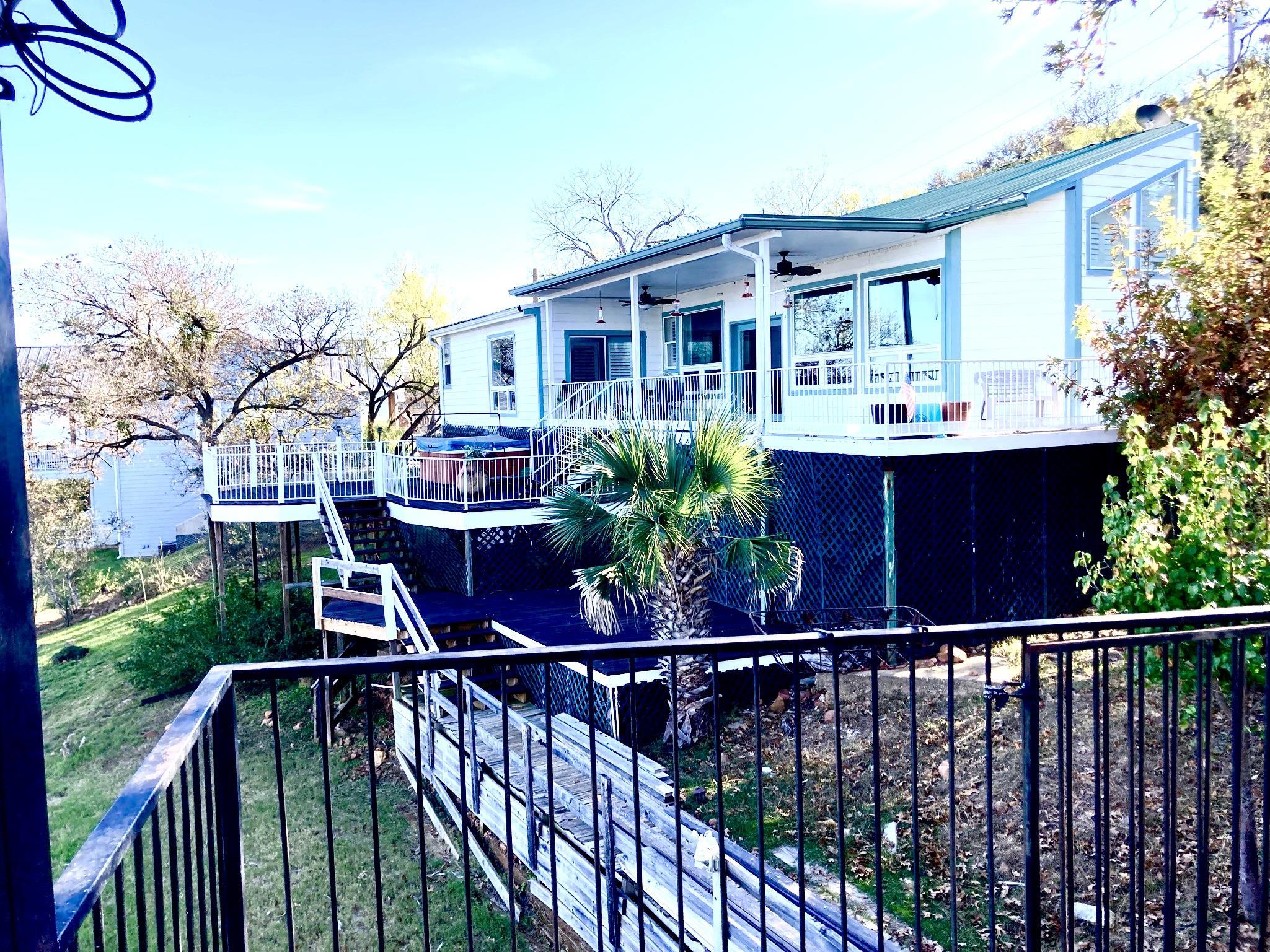 215 Mountain Top Sunrise Beach, TX 78643 - Photo 2 of 29 a view of a house with wooden deck