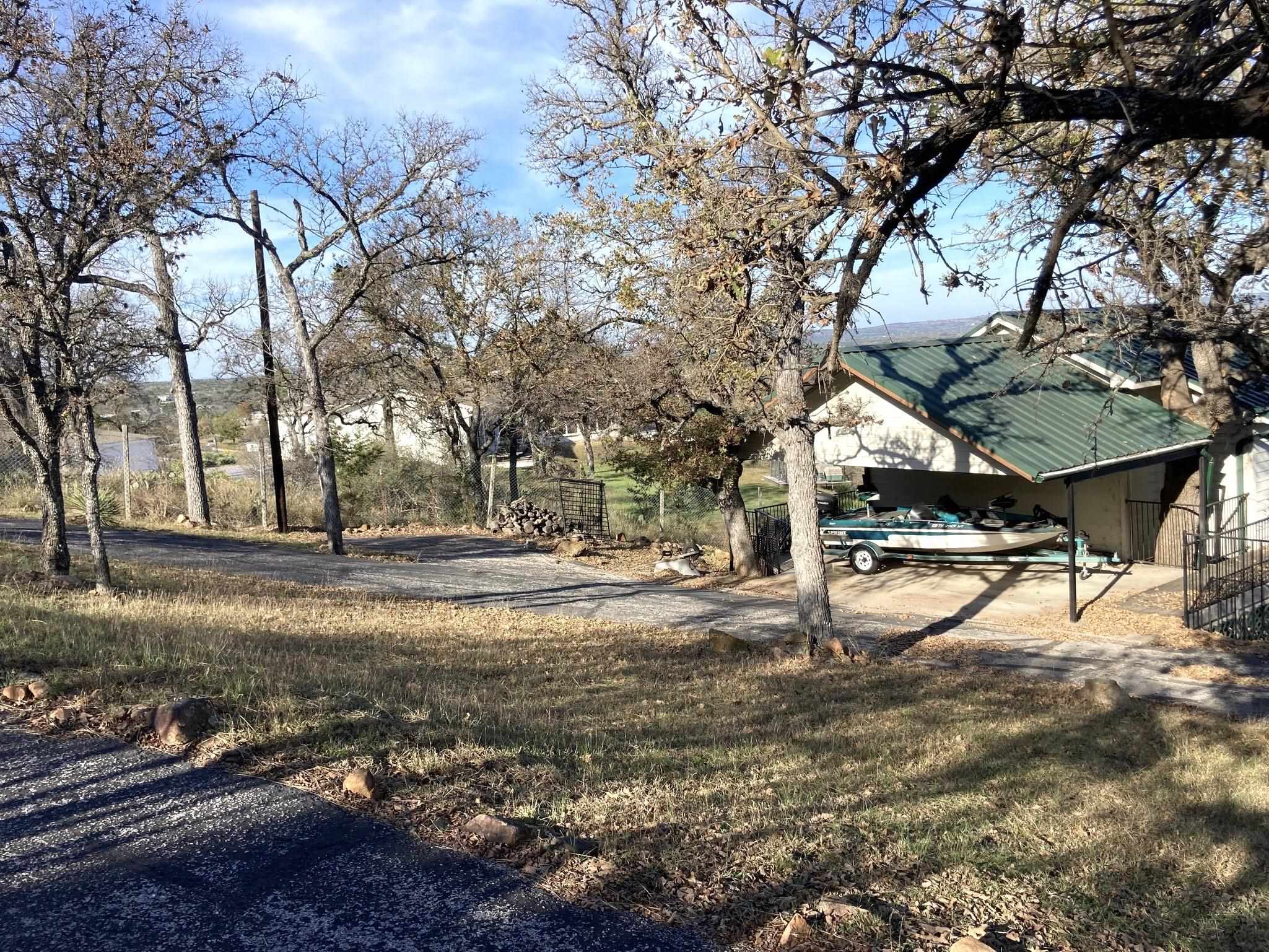 215 Mountain Top Sunrise Beach, TX 78643 - Photo 28 of 29 a view of yard with tree in the background