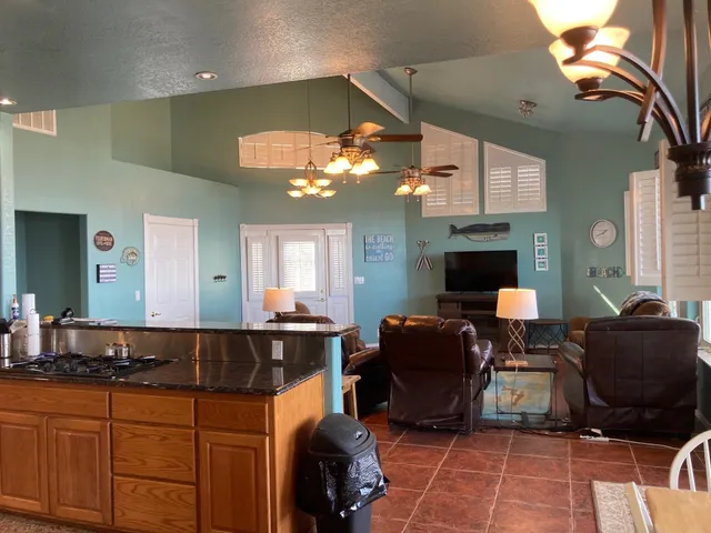 a view of a dining room with furniture and a chandelier