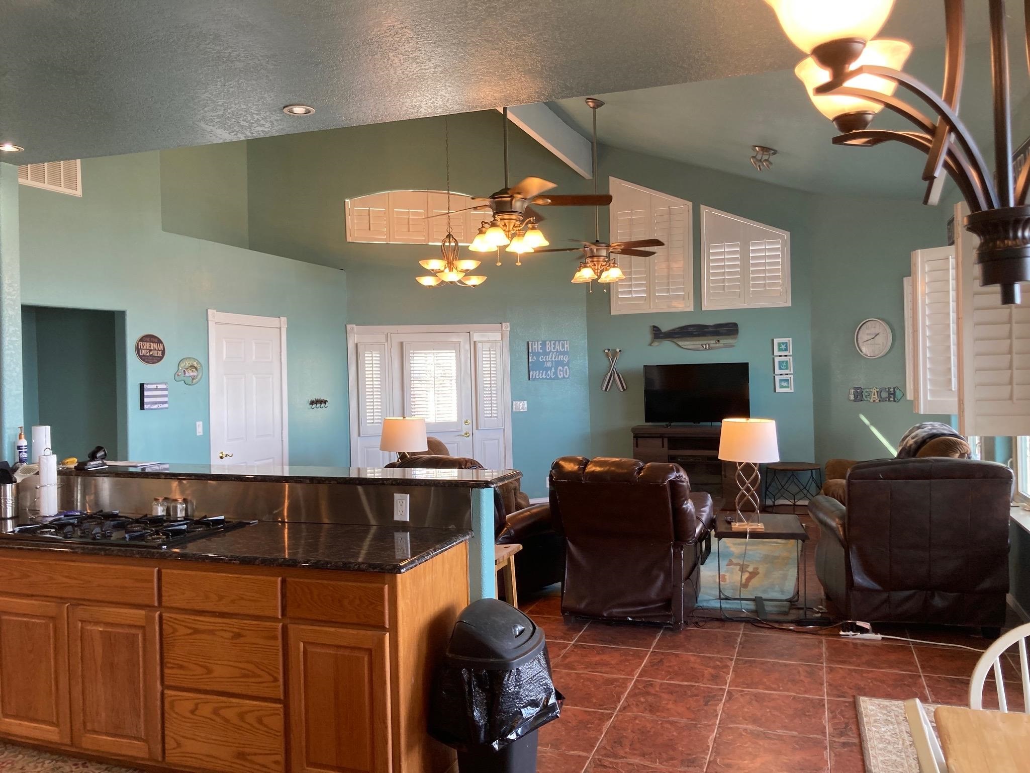 215 Mountain Top Sunrise Beach, TX 78643 - Photo 6 of 29 a living room with furniture a fireplace and a chandelier