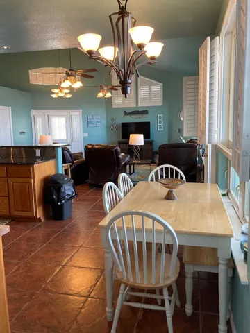 a view of a chairs and table in patio of the house