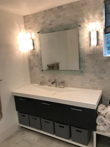 a bathroom with a sink vanity and a mirror