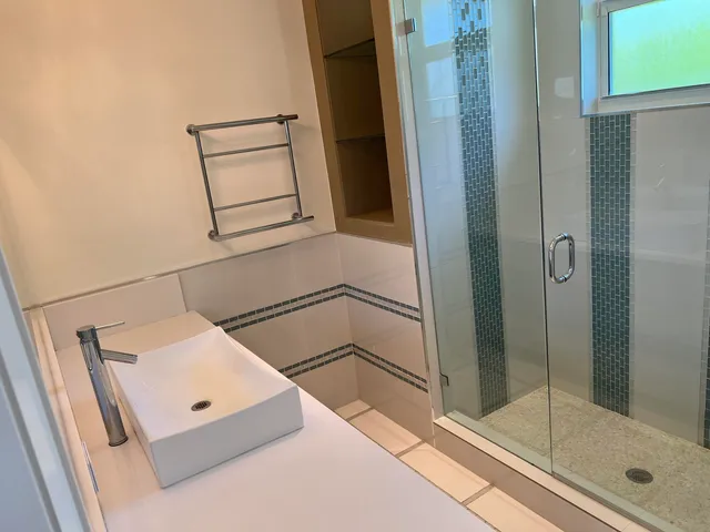a bathroom with a bathtub and shower
