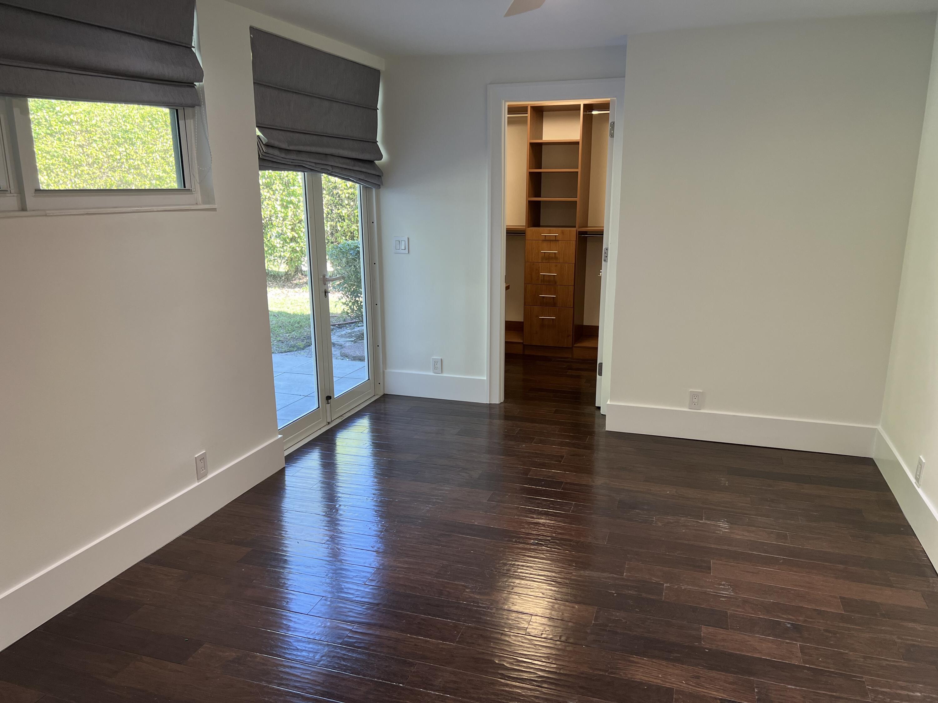 20981 Verano Way Boca Raton, FL 33433 - Photo 14 of 20 an empty room with wooden floor and windows